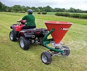 ATV-towed broadcast spreader.