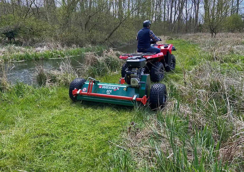 Red ATV with attached mower.