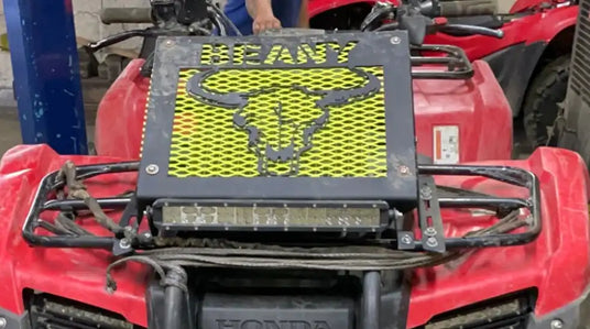 Red Honda ATV with custom grill.