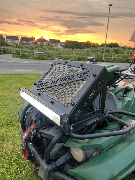 Green ATV with custom black front rack and LED light bar in Radiator Relocation Kits collection
