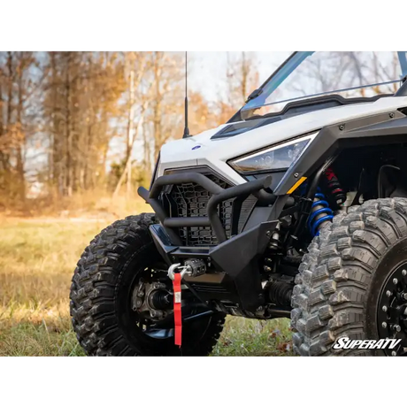 White off-road utility vehicle with winch and large tires in Superatv Bumpers collection